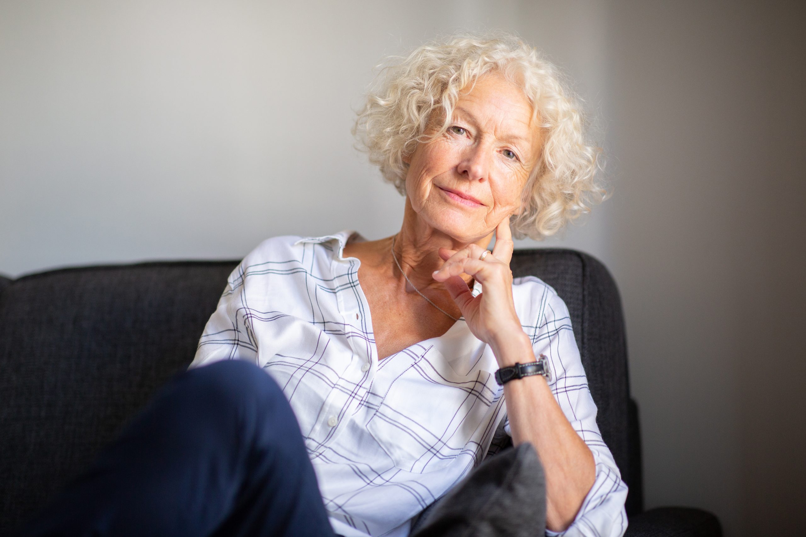 Portrait,Older,Woman,Relaxing,On,Sofa,At,Home